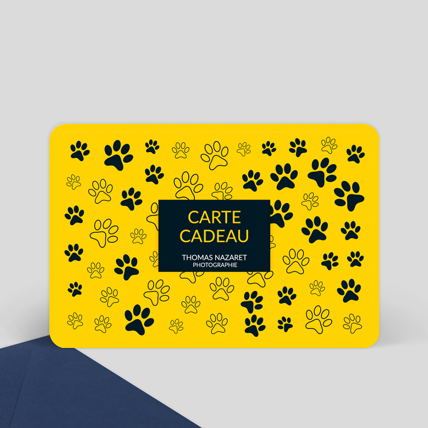 Photo du recto d'une carte cadeau jaune avec plein d'empruintes de chien. Au centre est inscrit dans un cadre noir Carte cadeau Thomas NAZARET Photographie.